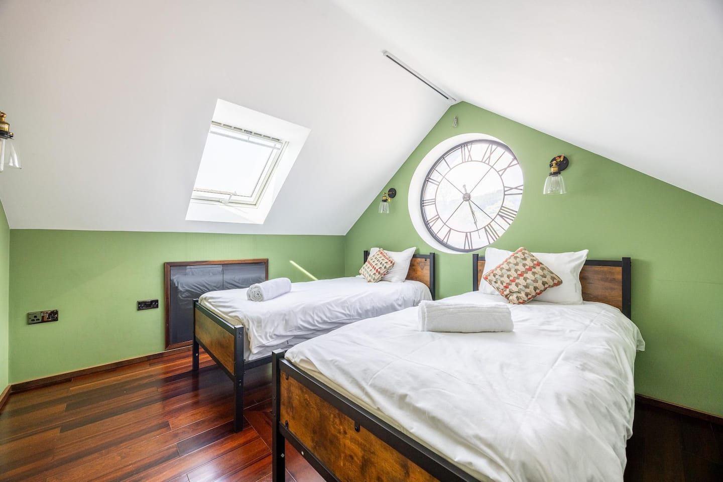 Clock-room Studio Suite with two single beds beneath apex Velux skylights — penthouse Bristol