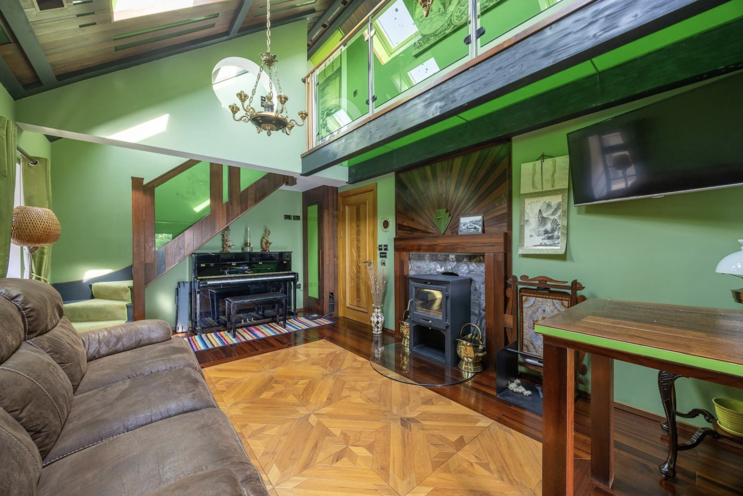 Vaulted drawing room with leather sofa, grand piano and wood burner — Belmont Deco Noir penthouse Bristol