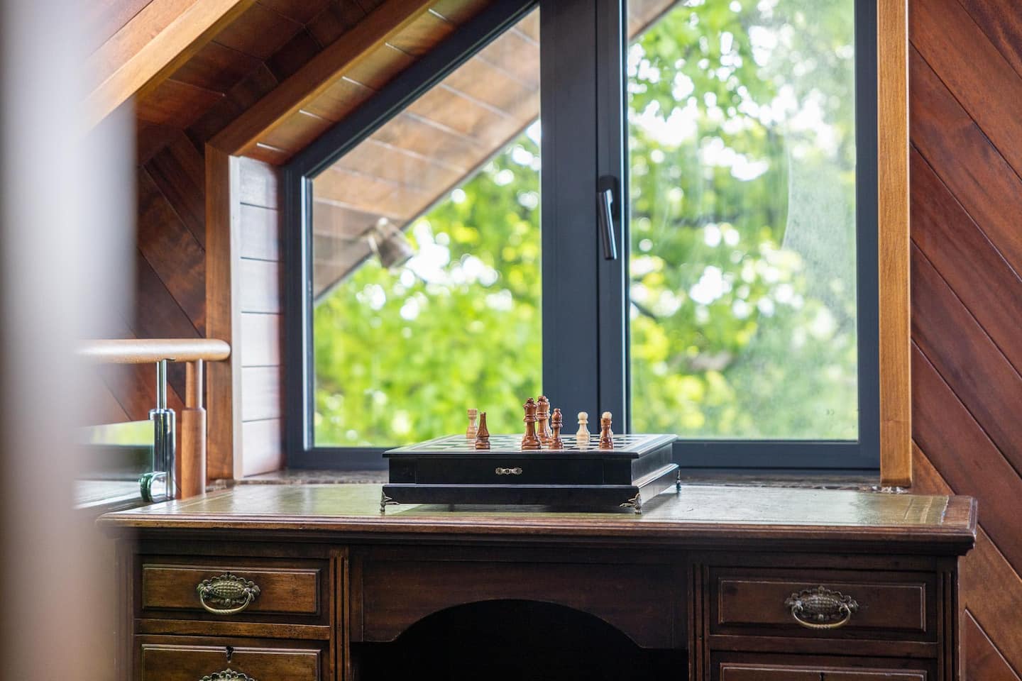 Private mezzanine study with antique desk and chess set — penthouse Bristol